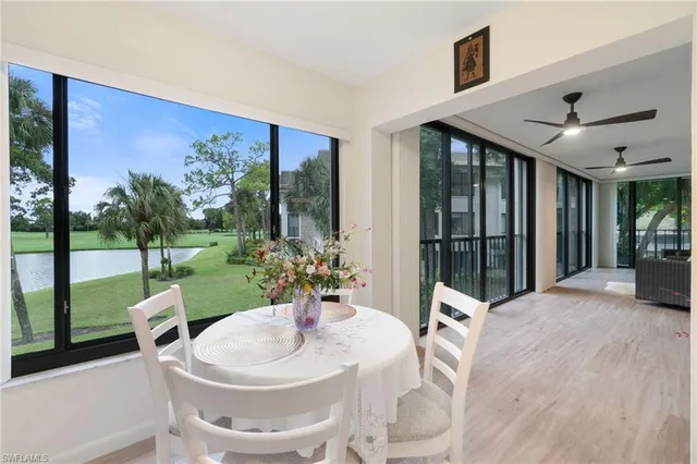 a very nice looking dining room with a large window and dining table