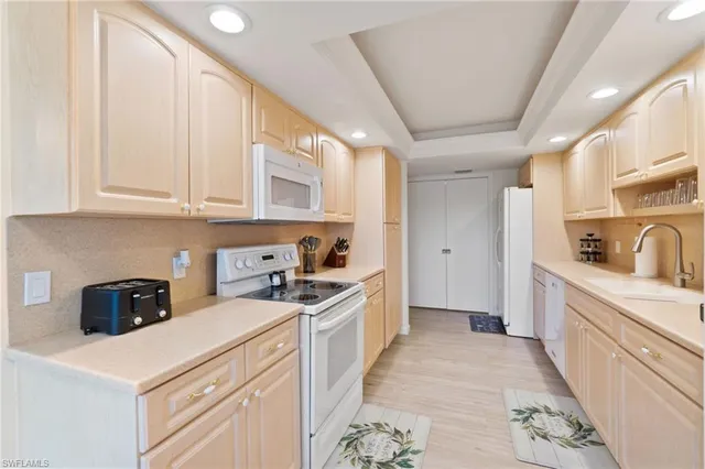 a kitchen with stainless steel appliances white cabinets and a sink