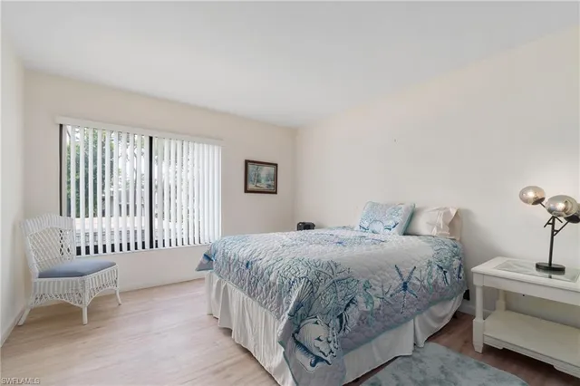 a bedroom with a bed and a chair