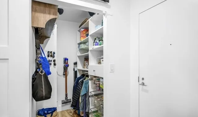a view of walk in closet with clothes and shoes