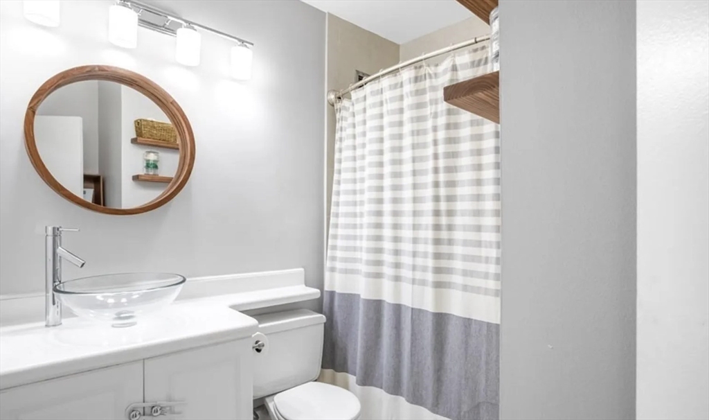 42 8th Street, Unit 3103 Boston, MA 02129 - Photo 9 of 11 a bathroom with a sink a mirror and a toilet