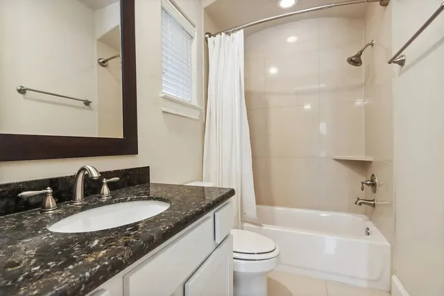 a bathroom with double vanity sinks and a mirror