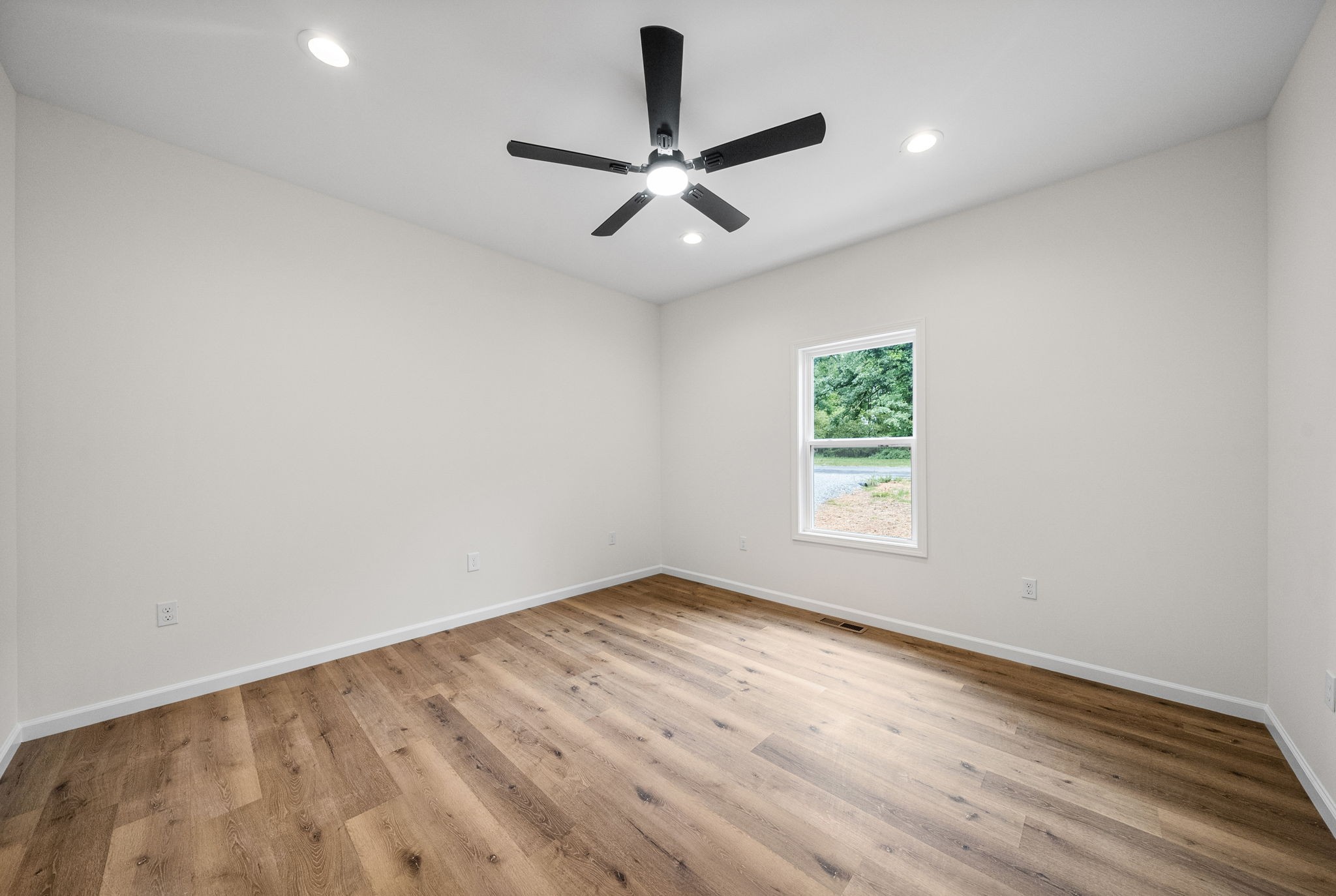 690 Brazzle Road Waverly, TN 37185 - Photo 17 of 35 wooden floor in an empty room with a window