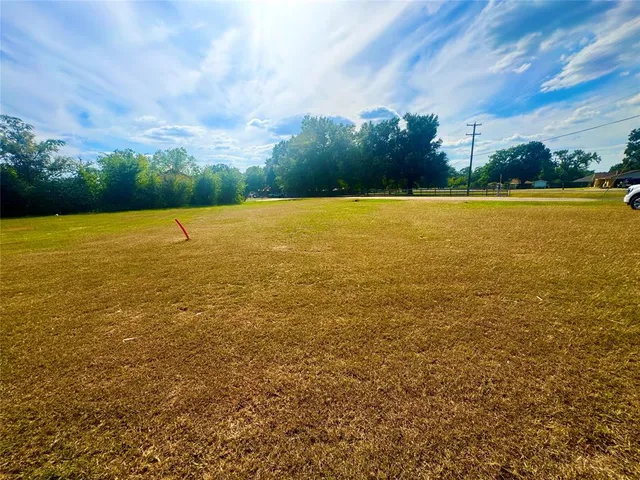 a view of a street with cars parked