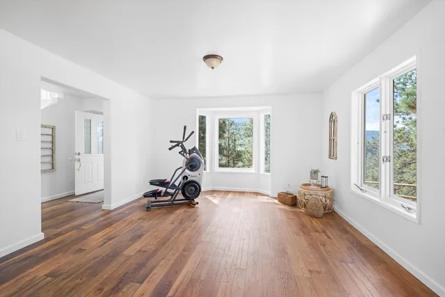 a view of a room with gym equipment and a window