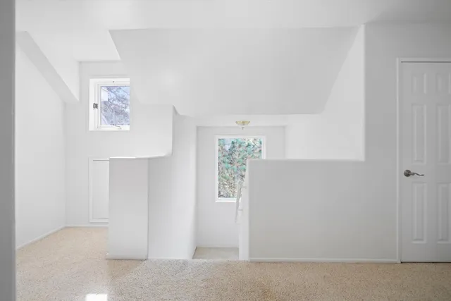 a room with a bed and a chandelier