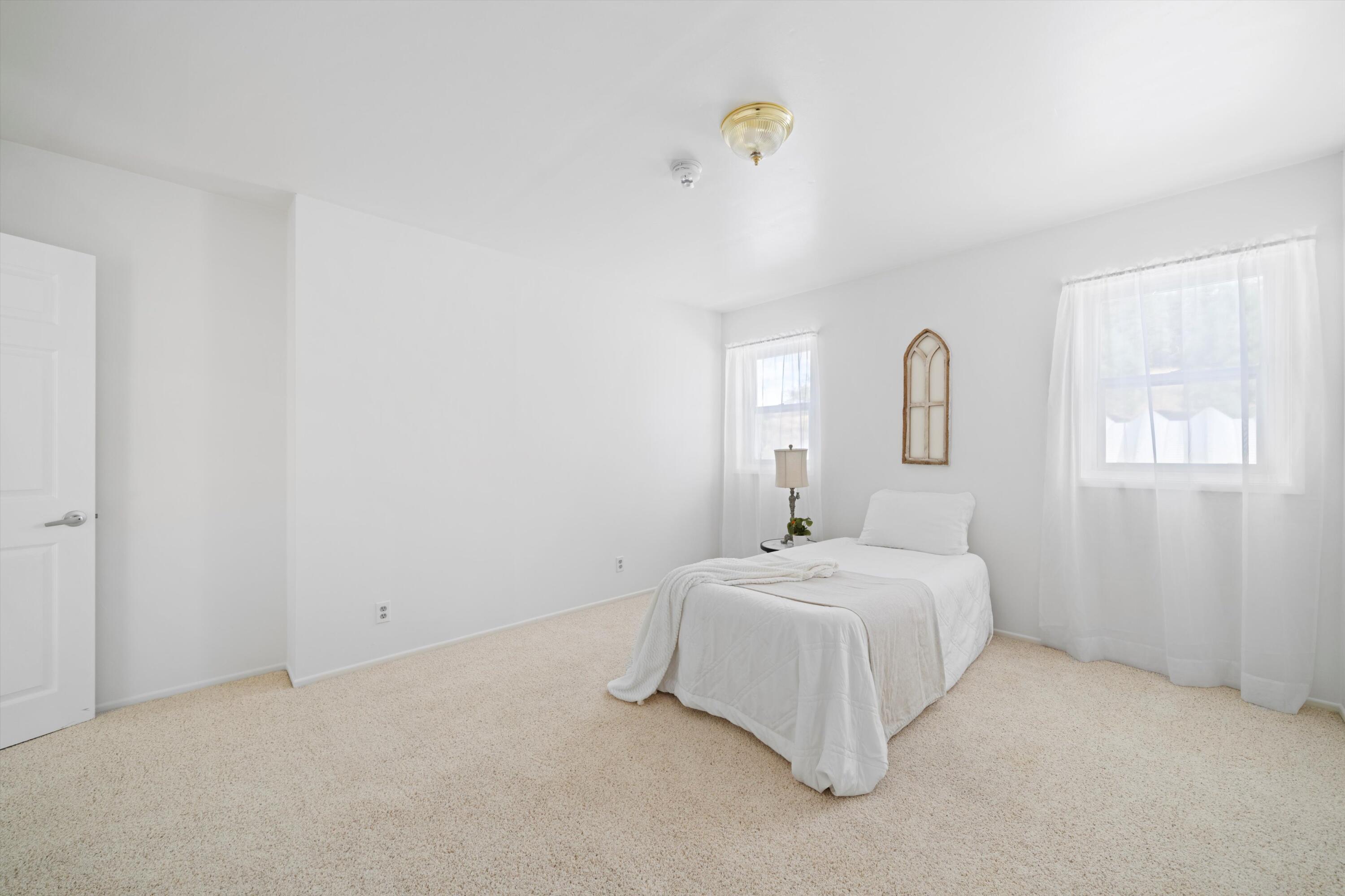 16930 Grindelwald Drive Tehachapi, CA 93561 - Photo 19 of 45 a room with a bed and a chandelier