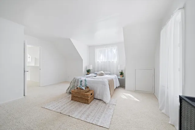a spacious bathroom with a granite countertop sink and a mirror