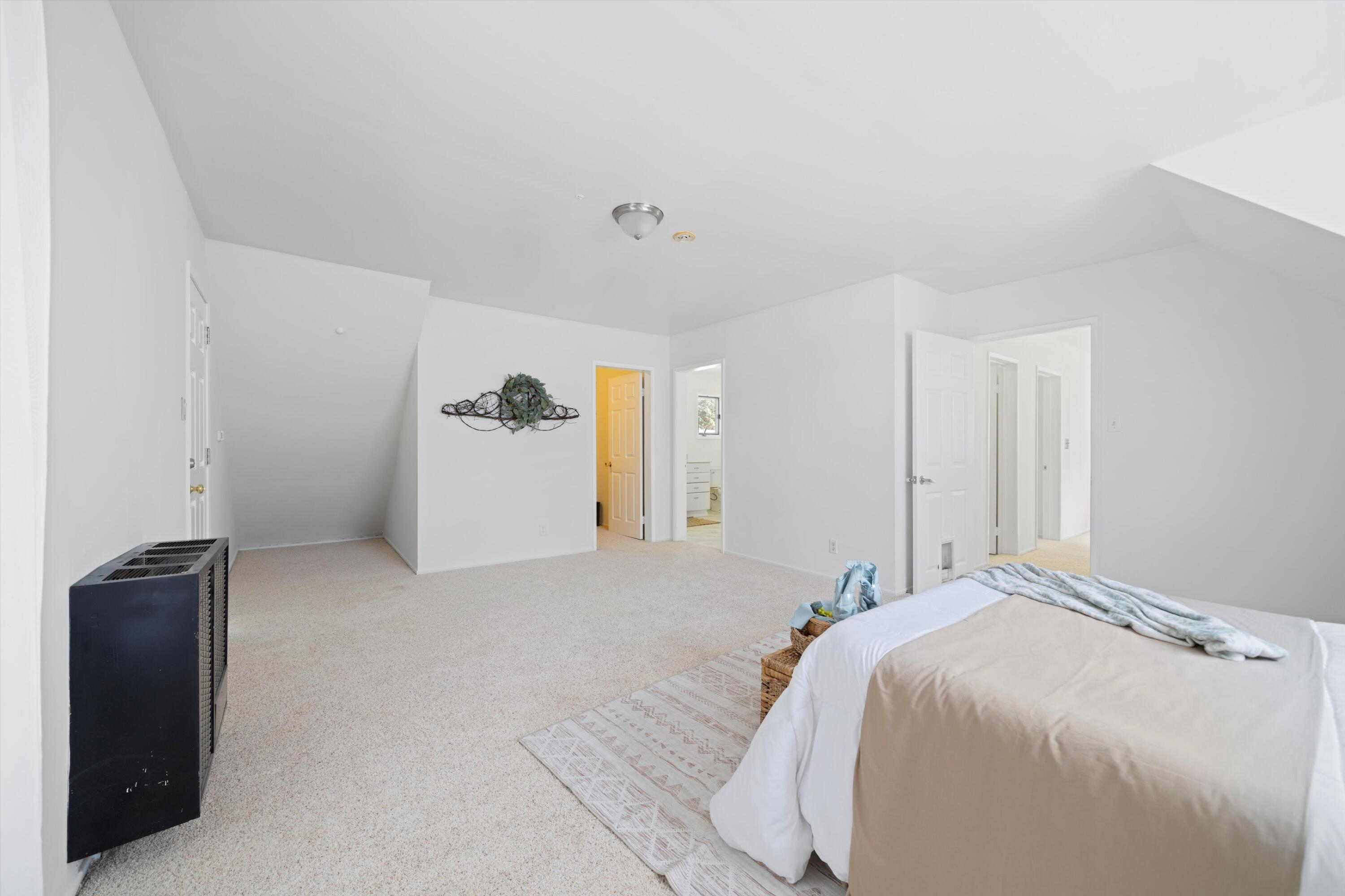 16930 Grindelwald Drive Tehachapi, CA 93561 - Photo 25 of 45 a bed room with a bed and a refrigerator