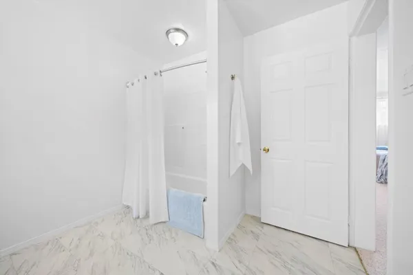 a bathroom with a granite countertop toilet sink and mirror