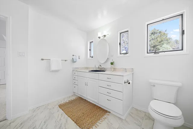 a bathroom with a sink a toilet and shower curtain