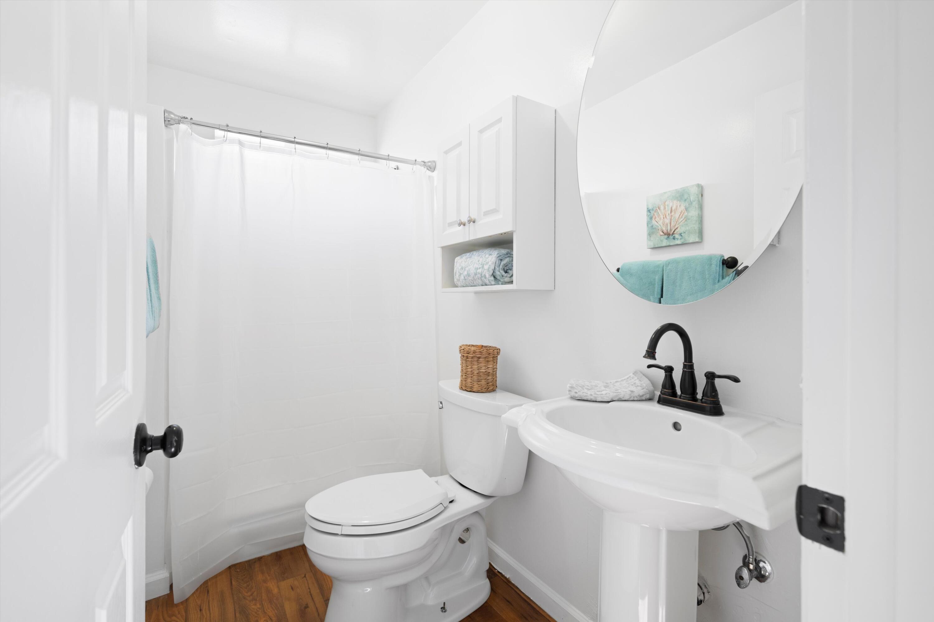 16930 Grindelwald Drive Tehachapi, CA 93561 - Photo 31 of 45 a bathroom with a sink a toilet and shower curtain