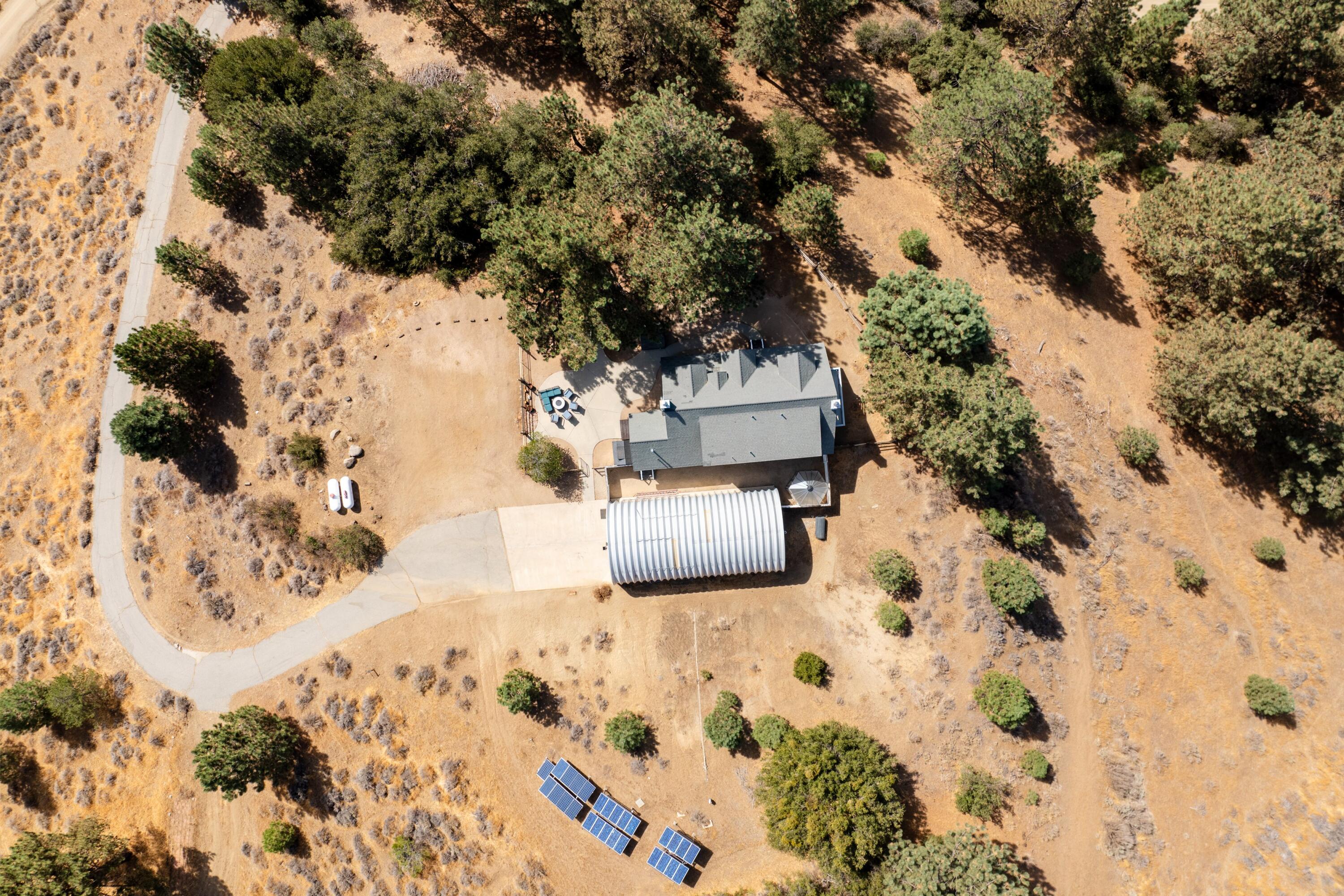 16930 Grindelwald Drive Tehachapi, CA 93561 - Photo 36 of 45 a view of white house with a yard covered with snow
