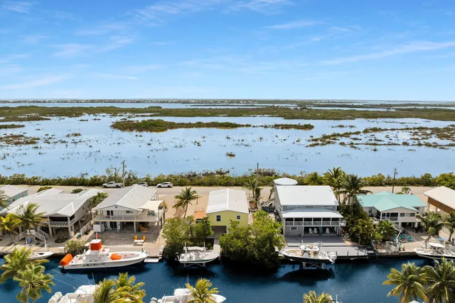 a street sign on a wall next to a road
