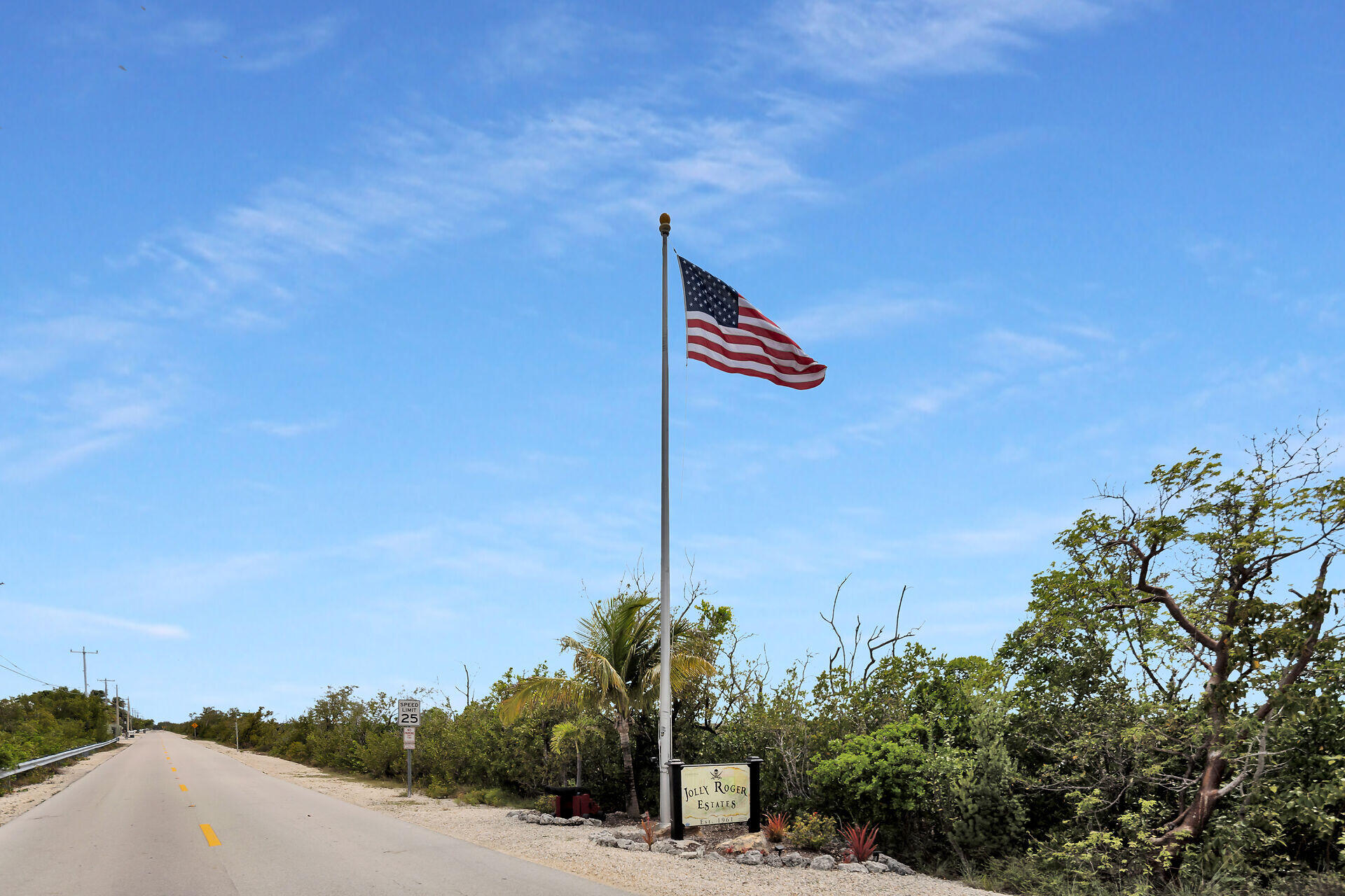 437 Pirates Road Summerland Key, FL 33042 - Photo 38 of 39 a street sign on a wall next to a road