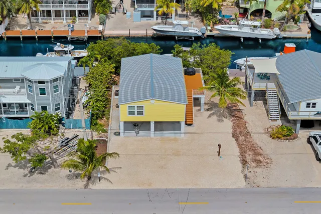 an aerial view of a swimming pool with outdoor seating