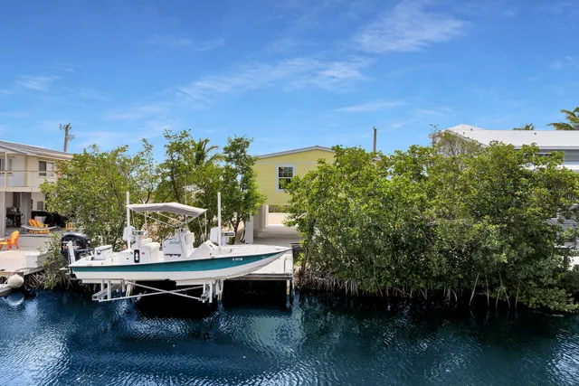 a roof deck with table and chairs