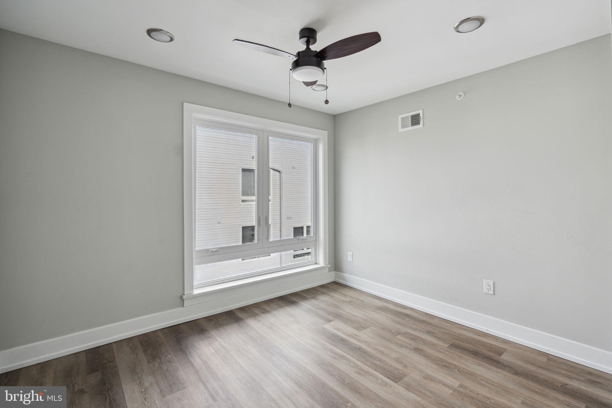 1930 North 2nd Street, Unit 2A Philadelphia, PA 19122 - Photo 20 of 23 wooden floor in an empty room with a window