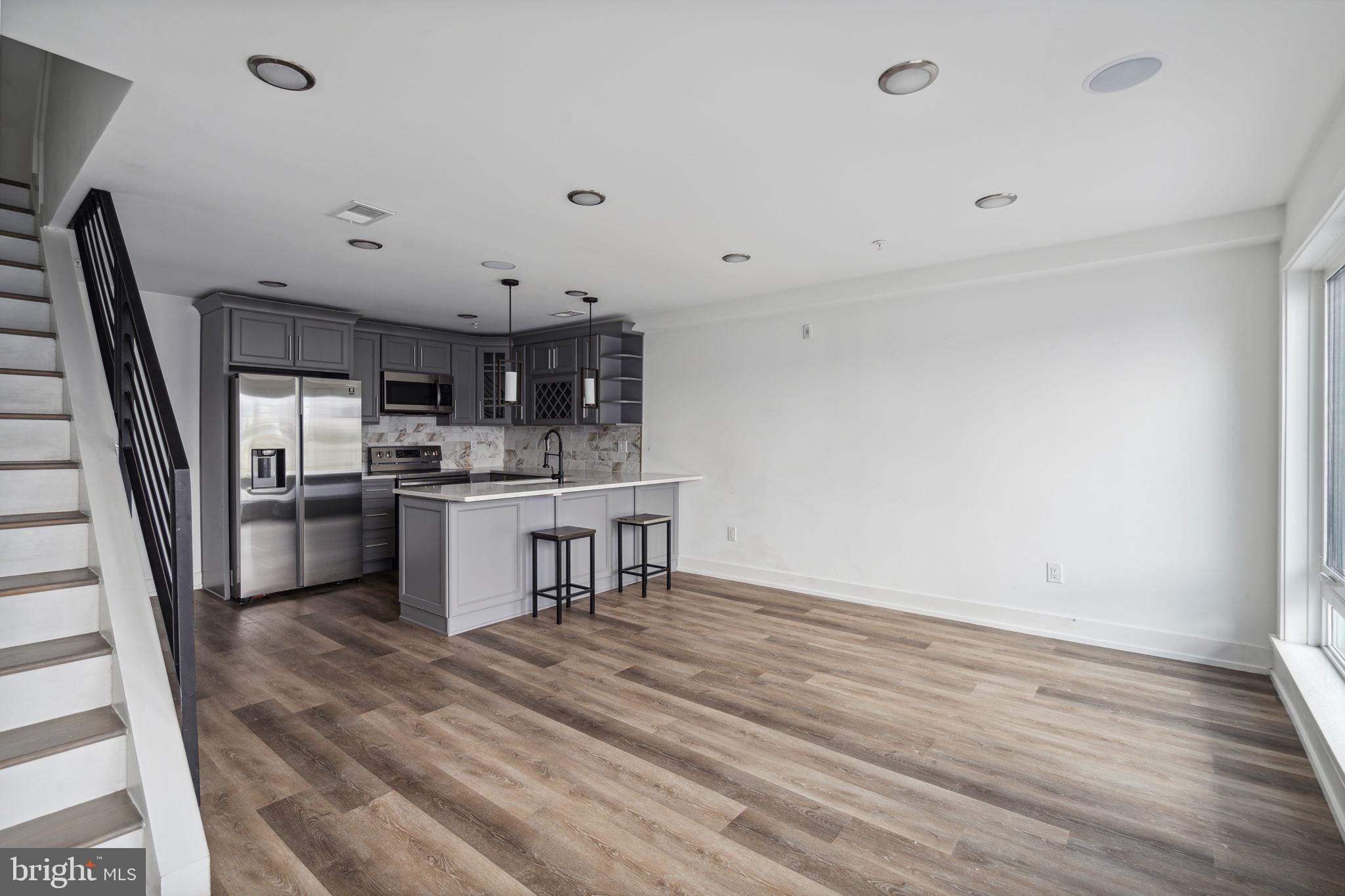 1930 North 2nd Street, Unit 2A Philadelphia, PA 19122 - Photo 4 of 23 a kitchen with a sink stainless steel appliances and cabinets