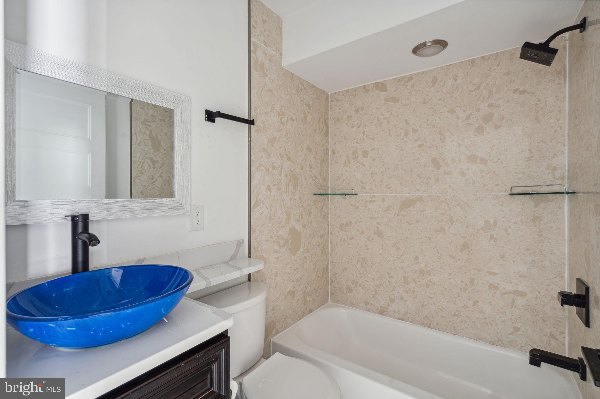 1930 North 2nd Street, Unit 2A Philadelphia, PA 19122 - Photo 9 of 23 a bathroom with a blue tub shower sink and vanity