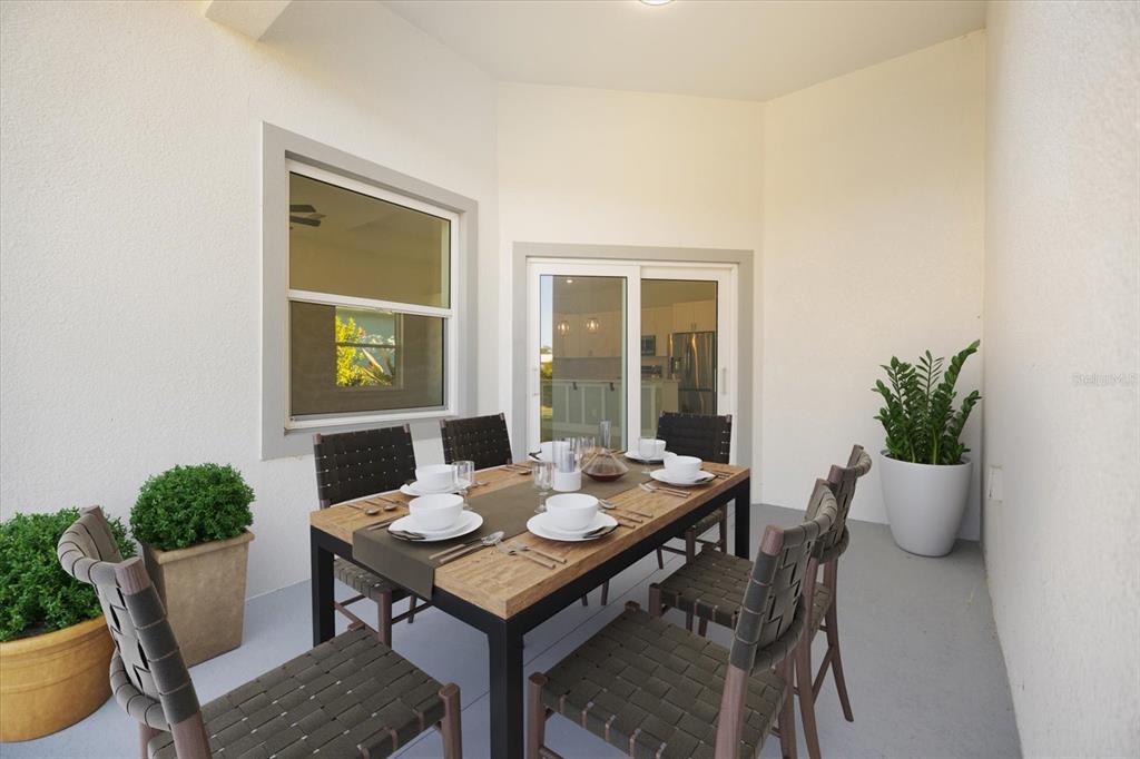 482 Sunset Road North Rotonda West, FL 33947 - Photo 12 of 45 a dining room with furniture and wooden floor