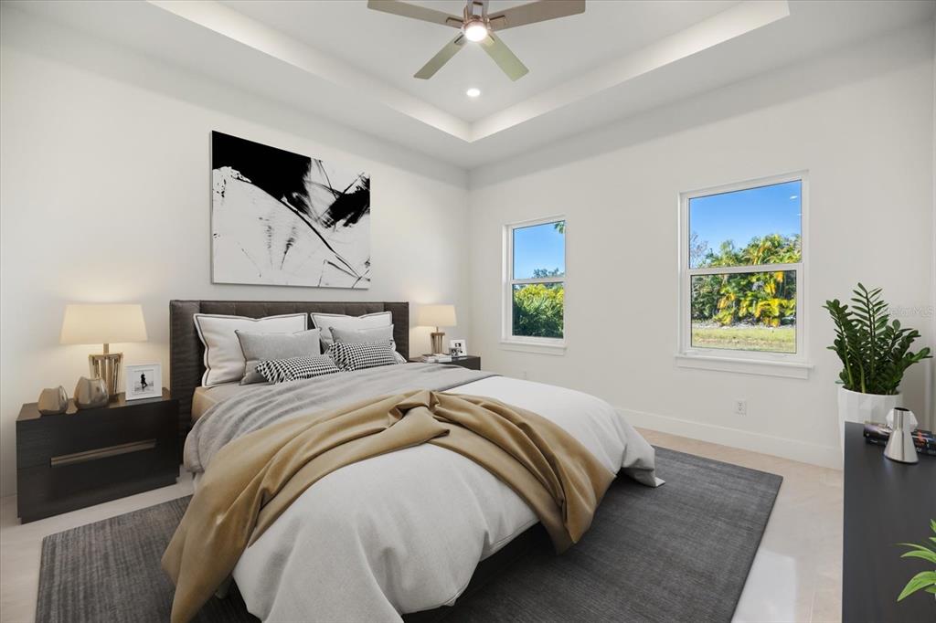 482 Sunset Road North Rotonda West, FL 33947 - Photo 21 of 45 a bedroom with bed and a chandelier