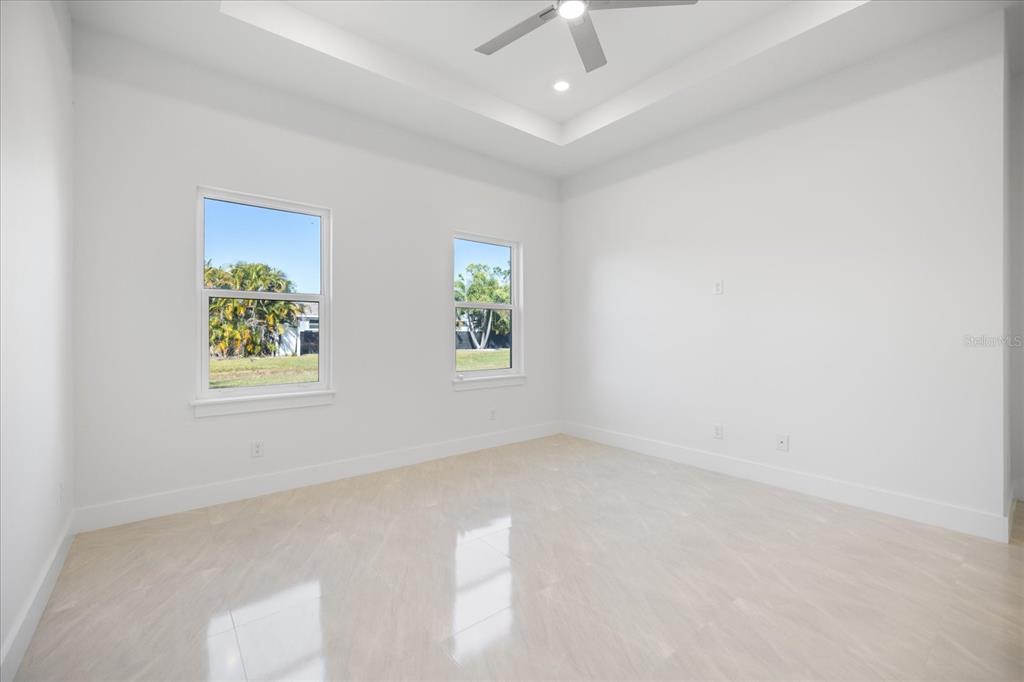 482 Sunset Road North Rotonda West, FL 33947 - Photo 25 of 45 an empty room with windows and fan