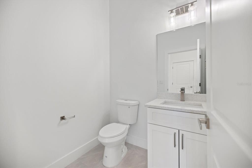 482 Sunset Road North Rotonda West, FL 33947 - Photo 35 of 45 a bathroom with a toilet a sink a mirror and vanity
