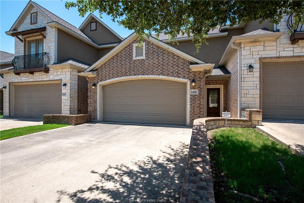 View of front of house with concrete driveway, stone siding, stucco siding, and an attached garage