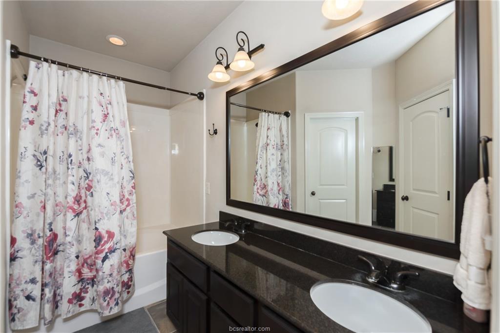 1408 Cres Ridge Drive College Station, TX 77845 - Photo 11 of 19 Primary bathroom featuring double vanity and garden tub/shower combo.