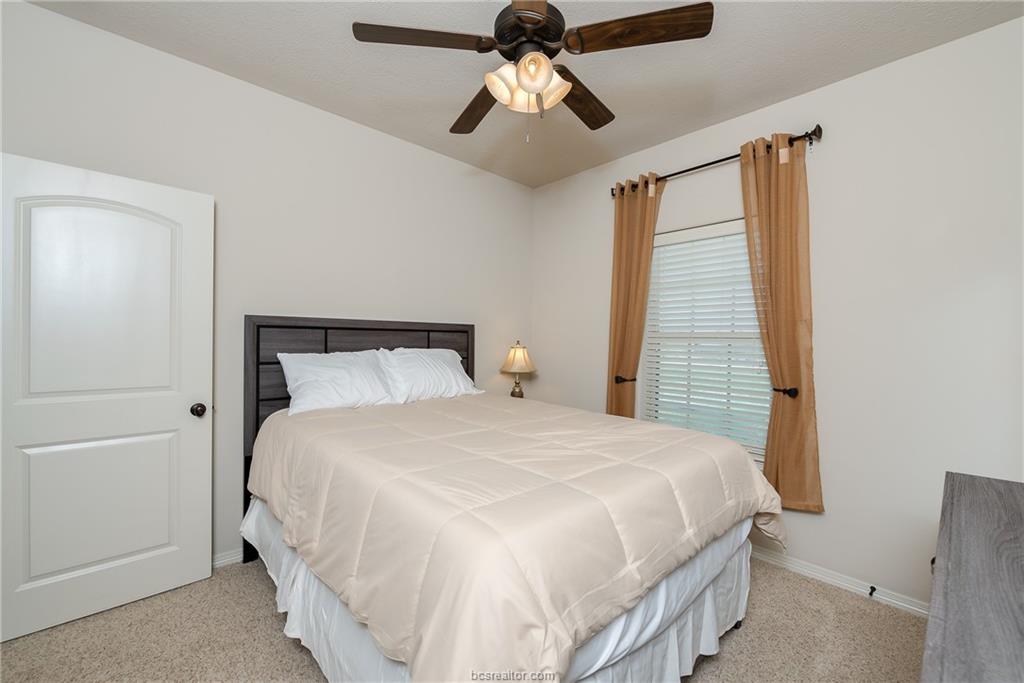 1408 Cres Ridge Drive College Station, TX 77845 - Photo 14 of 19 a bedroom with a bed and ceiling fan