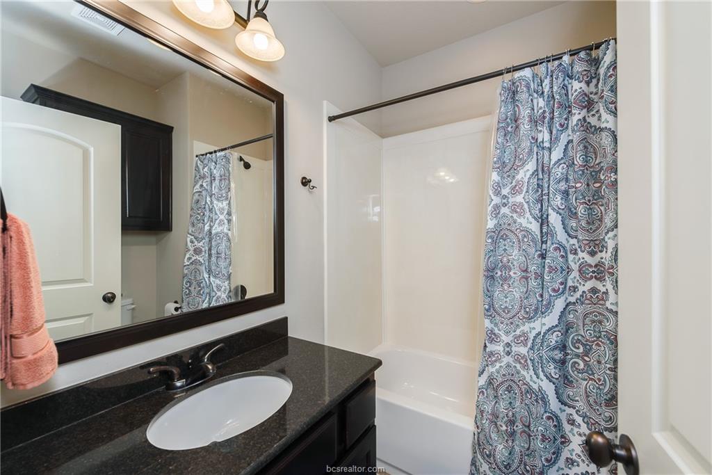 1408 Cres Ridge Drive College Station, TX 77845 - Photo 15 of 19 a bathroom with a sink and a mirror
