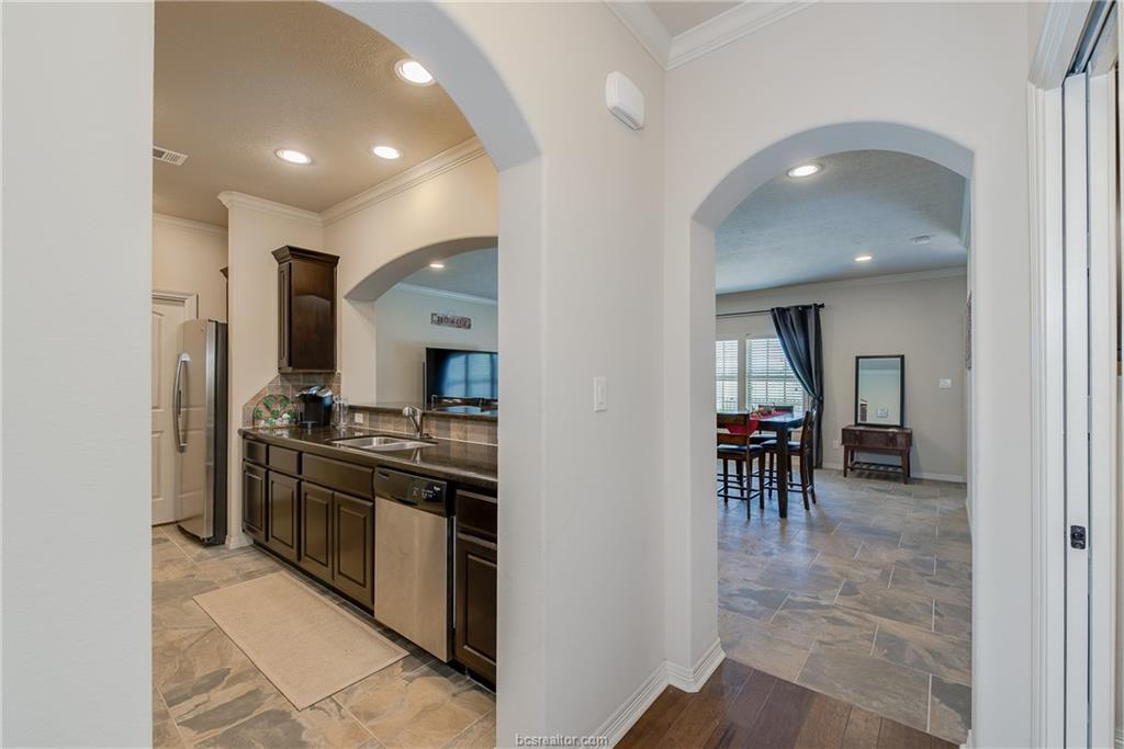 1408 Cres Ridge Drive College Station, TX 77845 - Photo 8 of 19 a kitchen with stainless steel appliances granite countertop a stove and a refrigerator