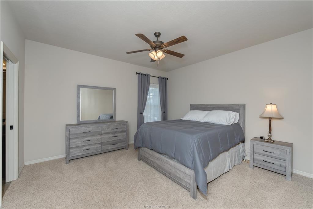 1408 Cres Ridge Drive College Station, TX 77845 - Photo 10 of 19 a spacious bedroom with a bed and a ceiling fan