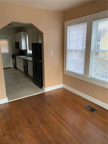an empty room with windows and cabinet