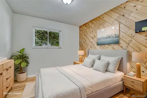 a bedroom with a bed potted plant and a window