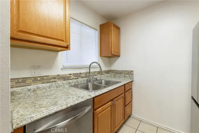 a kitchen with wooden cabinets and a stove top oven