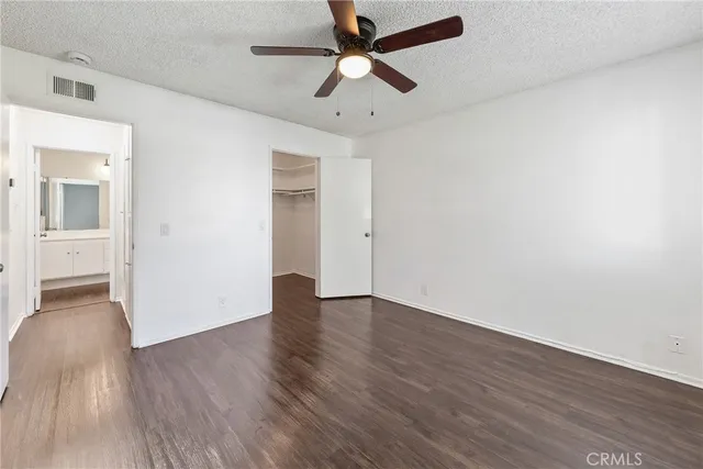 a spacious bathroom with a double vanity sink a mirror and a shower