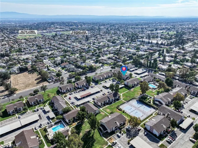 an aerial view of a houses with a yard
