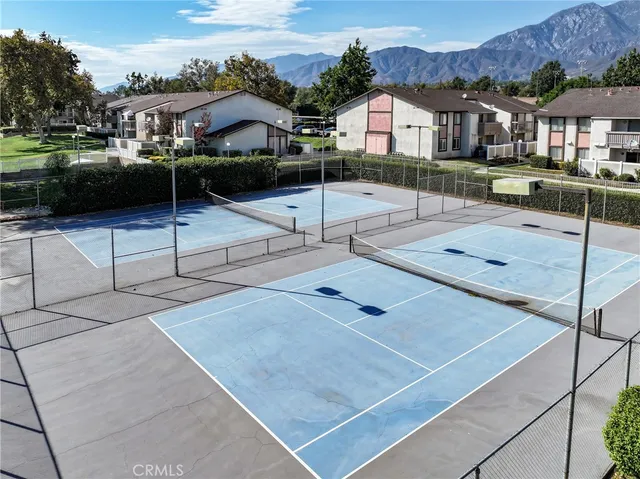 a view of a patio with table and chairs with wooden floor and fence