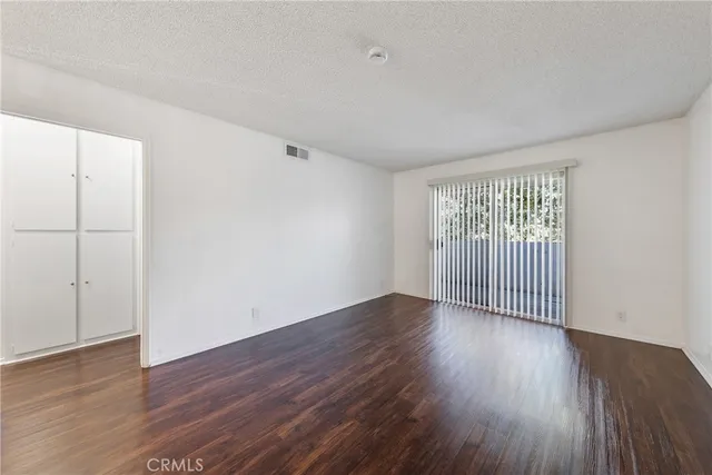 a kitchen with granite countertop a stove a sink and a refrigerator