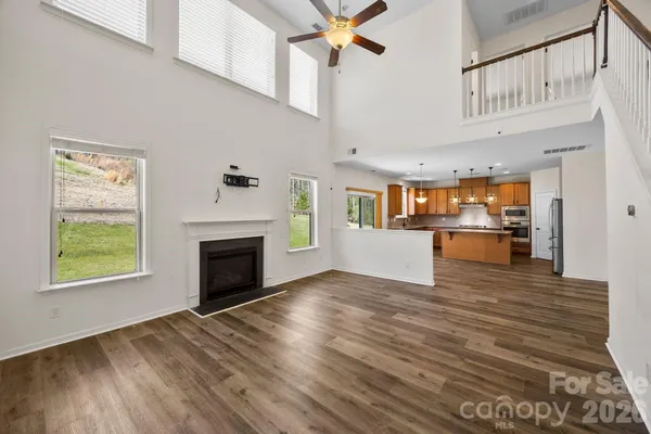 a view of a living room kitchen with furniture and fireplace