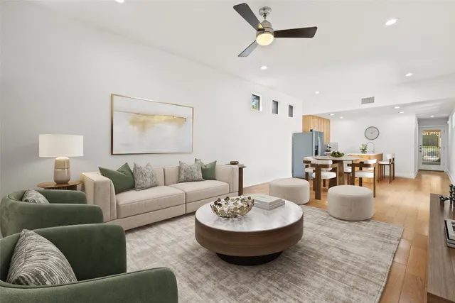 a living room with furniture and a potted plant
