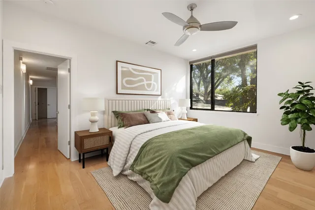 a view of a hallway with wooden floor and staircase