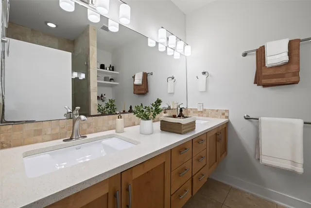 a bedroom with a large bed couch and a window