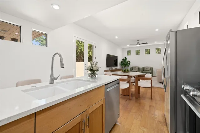 a kitchen with sink a stove and a microwave oven
