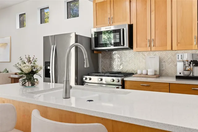 a kitchen with a sink refrigerator and cabinets