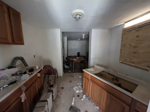 a kitchen that has a sink stove and cabinets