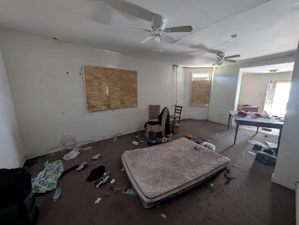 a room with gym equipment and a chandelier