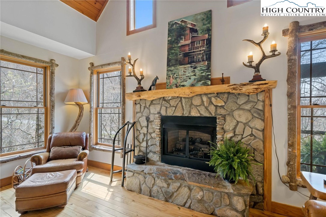 140 Spruce Hollow Road Beech Mountain, NC 28604 - Photo 9 of 50 a living room with furniture and a fireplace